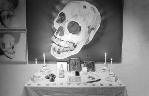 Traditional Day of the Dead altar decorated with cempasúchil, candles, papel picado and food, honoring the deceased according to Mexican tradition